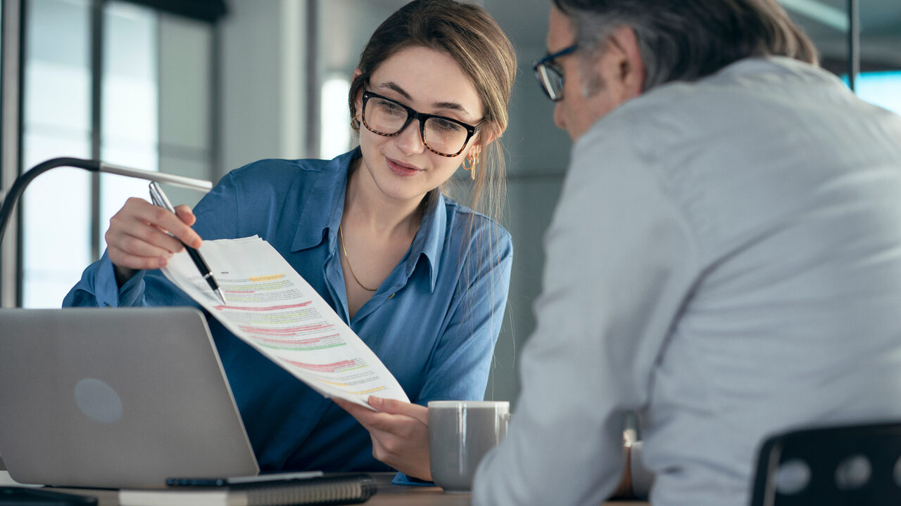 Business owner reviewing succession planning documents with adviser