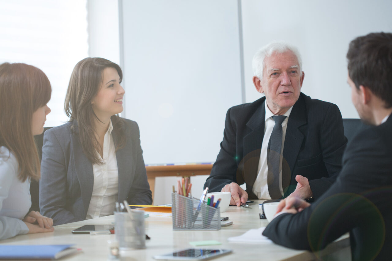Family business succession planning meeting across generations